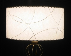 white drum lampahade wth arc pattern, by Meteor LIghts